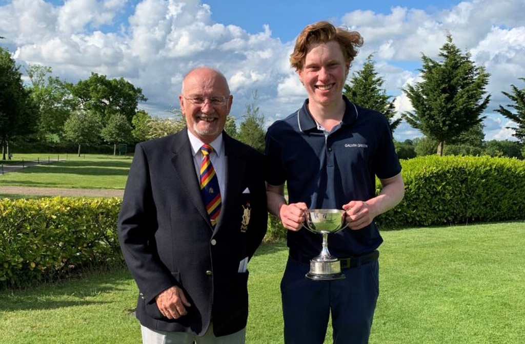 Finlay Cummings is alongside a tournament official as he becomes county champion in May 2021 while captain of Bedford School