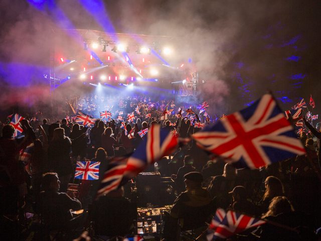 A sea of union jack flag with the stage in at the background at Bedford Park Proms. Image: Cuffe & Taylor