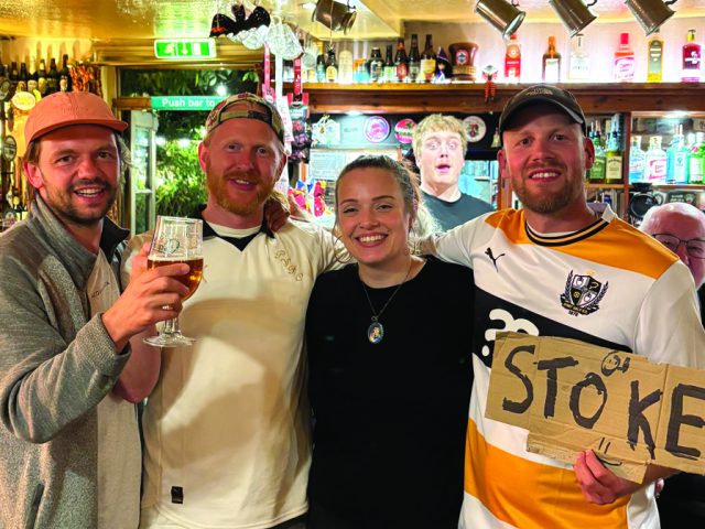 Danish hitchhikers Nikolaj, Mathias and Frederik with Emily Finney, bar manager at the Wellington Arms in Bedford. Image: Frederik