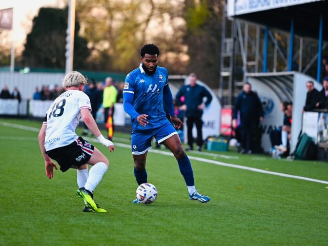 Bedford Town's Tyrone Marsh takes on a Darlington player at The Eyrie
