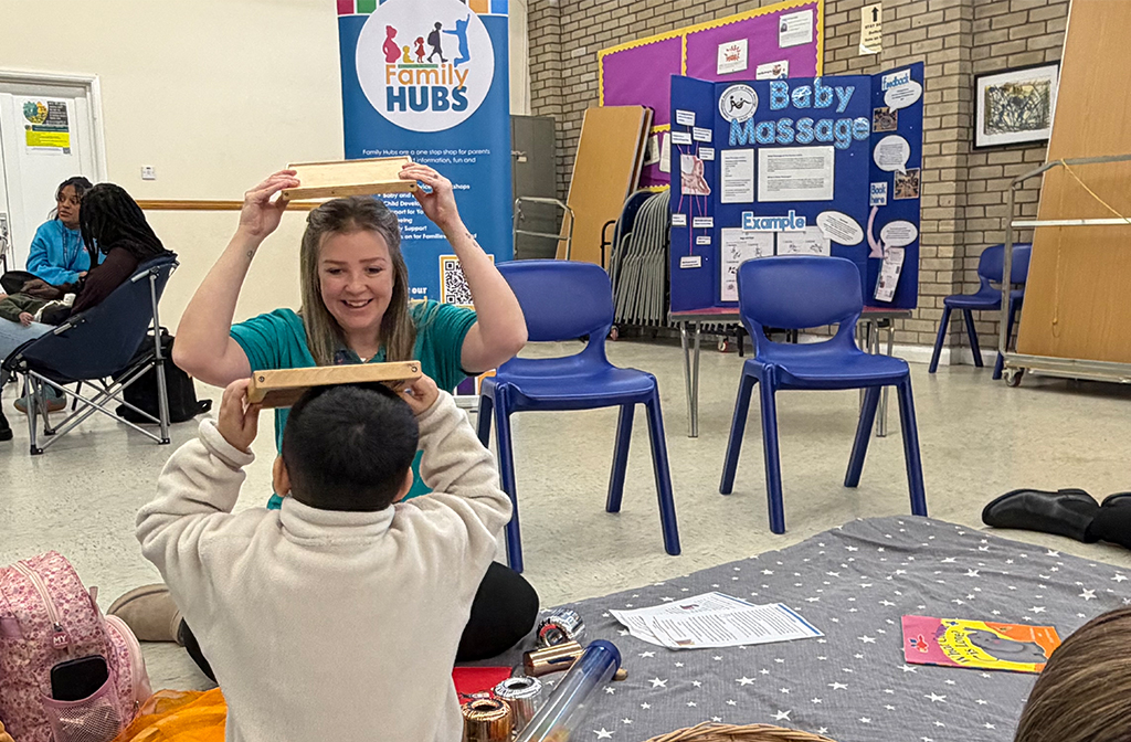 A Bedford Family Hub worker plays with a child. Image: Bedford Independent